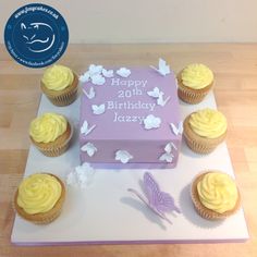 a birthday cake and cupcakes on a table