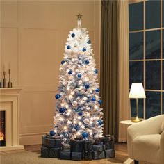 a white christmas tree with blue and silver ornaments