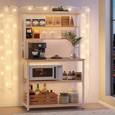 a kitchen with lights on the wall and a microwave in front of an open window