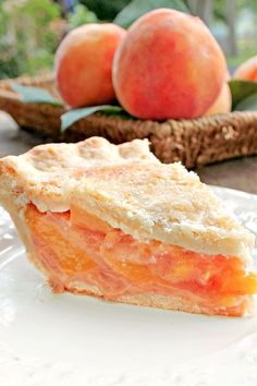 a slice of peach pie sitting on top of a white plate