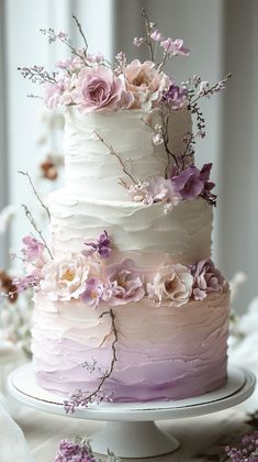 there is a multi layer cake with flowers on it