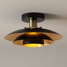 a black and gold light hanging from the ceiling