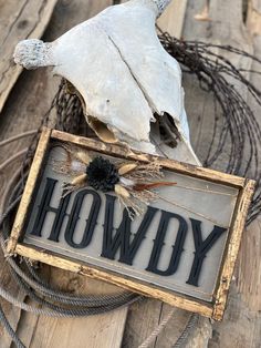 a sign that says howdy on it with a bird's head in the background