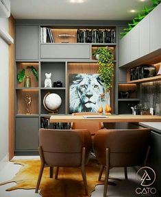 two brown chairs sitting in front of a desk with bookshelves on the wall