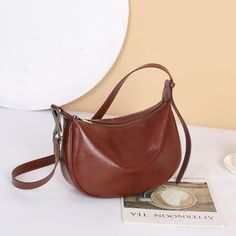 MATERIAL - Made of 100% high quality vegetable-tanned leather, solid color,feels cosy to touch,delicate, durable. The hardware parts are made of cast molding thick hardware, top metal hardware. The stitching is well-made, firm and smooth.DIMENSIONS - 11.4L*3.9W*7.9H(inches) / 29L*10W*20H(cm).STRUCTURE - This shoulder bag contains 1 main compartment, 1 inner slip pocket, 1 inner zipper pocket. Comfortably holds wallet, mobile phone, cosmetics, keys, charge, essentials and so on.FUNCTIONAL - Adjustable shoulder strap, can be crossbody bag, shoulder bag, handbag.OCCASION - The women's real leather crossbody purse made by professional artisans, appearance concise, elegant. Perfect for dating, shopping, working, traveling, vocation, party and other occasions and keep your daily items well organ Modern Brown Satchel With Single Shoulder Strap, Elegant Brown Saddle Bag With Single Shoulder Strap, Brown Solid Color Shoulder Bag For Everyday Use, Versatile Brown Hobo Bag With Single Shoulder Strap, Elegant Brown Saddle Bag For Fall, Modern Brown Saddle Bag For Daily Use, Versatile Brown Satchel With Single Shoulder Strap, Versatile Brown Saddle Bag For Daily Use, Trendy Brown Saddle Bag For Everyday