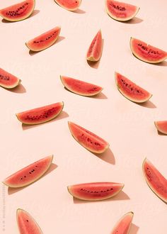 slices of watermelon are arranged on a white surface