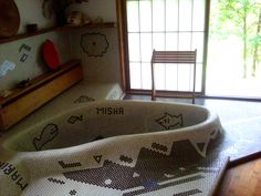 a bathtub in the middle of a room with an animal themed rug on it