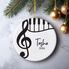 a personalized ceramic ornament hanging from a christmas tree