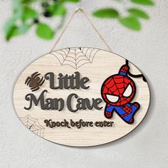 a wooden sign hanging from the side of a wall that says, little man cave