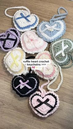 several crocheted heart ornaments on a wooden table