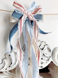 an old pair of jeans tied to a rope with a bow on top of it