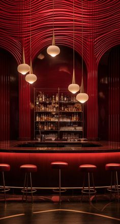 a bar with stools and lights hanging from it's red ceiling, along with several bottles on the shelves