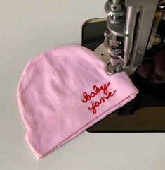 "・Personalized lettering is hand cranked on an antique chainstitch embroidery machine from 1927. ・This hat is oversized for an average newborn's head, which means they can wear it as they grow during their first year. ・100% cotton, available in one size. ・The font used on all hats is a handwritten cursive script. See photos for examples of different color options. ----- PRODUCTION TIME ----- Production time for all customized products is 2 weeks. Need it sooner? - Add the RUSH upgrade to your or Personalized Baby Hat, Hat Club, Personalized Baby Shower Gifts, Personalized Onesie, Baby Boy Knitting, Chain Stitch Embroidery, Cursive Script, Newborn Baby Hats, Stitch Shop