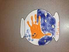 a child's drawing of a fish in a bowl with the name madison on it