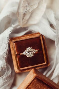 an engagement ring sitting in a velvet box