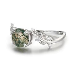 Break free from your thoughts and marvel at the beauty of our nature-inspired Between the Leaf Round Moss Agate Ring©. The astonishing round-shaped moss agate stone sits at the center of gracefully sculpted silver leaves with round gems for a hint of sparkle. ✦ Available in both 14K white gold vermeil (14K white gold plated over a sterling silver base) and 10K solid white gold. Silver Moss Agate Ring With Natural Inclusions, Elegant Silver Moss Agate Rings, Round Moss Agate Jewelry With Natural Stones, Nature-inspired Moss Agate Jewelry With Natural Inclusions, Nature-inspired Agate Rings With Natural Inclusions, Nature-inspired Round Jewelry With Natural Stones, Nature-inspired Moss Agate Jewelry For Anniversary, Nature-inspired Moss Agate Round Rings, Nature-inspired Moss Agate Rings