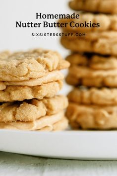 homemade peanut butter cookies stacked on top of each other in front of a white plate