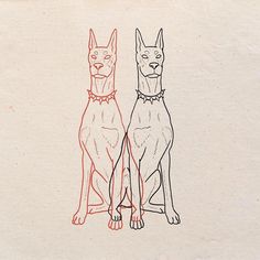 two dogs sitting side by side on top of a piece of paper with red and black ink