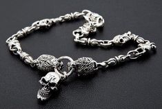 Express your fierce side with this stunning lion skull necklace. The two lions appear to be biting down onto the circle in the centre of the necklace. Dangling from the circle is a grinning, silver skull.Within the chain, you will be able to see several skulls that hold the chain together. These chains add to the boldness of this piece, and will certainly tie your outfit together. The easy to use clasp, and precise detail on each of the elements make this a piece you need in your collection.• Ap Luxury Engraved Skull Jewelry, Lion Skull, Two Lions, Onyx Ring Men, Mens Cross Necklace, Lion Necklace, Necklace Gothic, Animal Necklace, Biker Jewelry