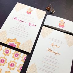 the wedding stationery is laid out on the table