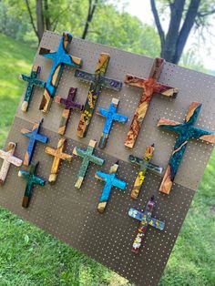 the crosses are made out of wood and have been placed on a board in the grass