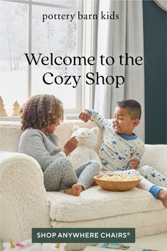 two children sitting on a couch with a teddy bear and bowl of cereal in front of them