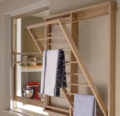 a wooden shelf with towels hanging on it