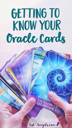 two hands holding up cards with the words getting to know your oracle cards on them