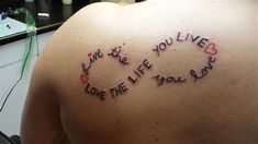 the back of a woman's shoulder with writing on it that says we are the love