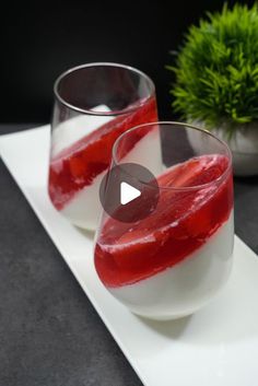 two glasses filled with liquid sitting on top of a white plate