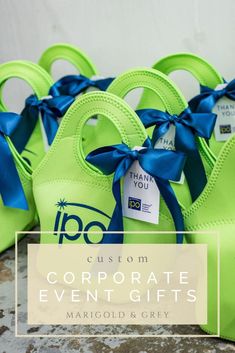 neon green purses with blue ribbon tied around them and the words, custom corporate event gifts