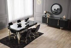 a black and gold dining table surrounded by chairs in front of a large mirror on the wall