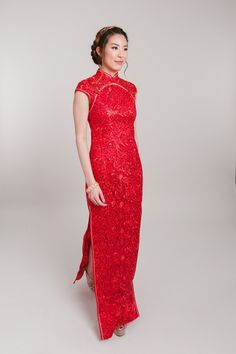 a woman in a red dress posing for the camera with her hands on her hips