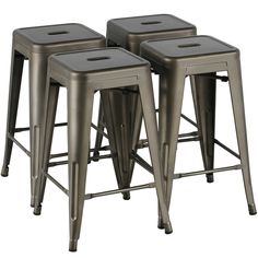 four metal stools are shown in this image