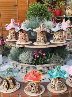 several bird houses are on display in a garden