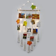 a wall hanging with pictures and lights on it