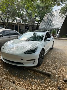 a white car parked in front of a building