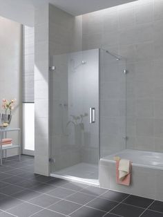 a bathroom with tiled flooring and walls, including a walk in shower next to a bathtub