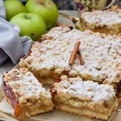 a close up of some food on a plate with apples and cinnamon sticks in the background