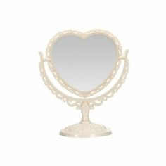 a white heart shaped mirror sitting on top of a stand