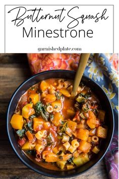 butternut squash minestone in a black bowl with a wooden spoon on the side