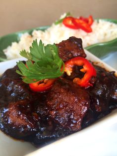 meat and vegetables on a plate with rice