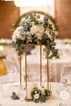 an elegant centerpiece with greenery and candles