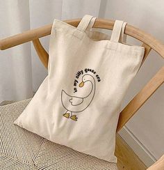 "Silly Goose Era Tote Bag, In My Silly Goose Era, Tote Bag, Silly Goose, Era Tote Bag, Funny Bag, Funny Gift, Gift For Her, Shopping Bag This 100% cotton bag comes in one size - 15\" x 16\"- perfect for everyday wear. While the canvas material shows off our designs, it's durable and will last for years. The bag features 20\" handles (made from the same canvas), making it easy to carry even with a week's worth of shopping. 100% cotton canvas Heavy fabric (12 oz/yd² (406.9 g/m Sewn-in label" Cute Cream Shoulder Bag For Daily Use, Cute Rectangular Cream Shoulder Bag, Cute Softback Shoulder Bag For Everyday Use, Cute Everyday Shoulder Bag With Softback, Cute Cream Rectangular Shoulder Bag, Cute Rectangular Beige Canvas Bag, Cute Everyday Use Softback Shoulder Bag, Cute Everyday Softback Shoulder Bag, Cute Beige Bags For Daily Use