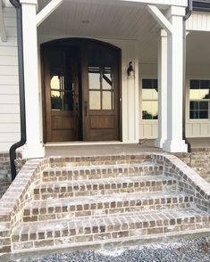 the front entrance to a house with steps leading up to it and two doors on each side