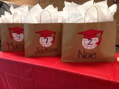 three brown paper bags with red caps and numbers on them are sitting on a table