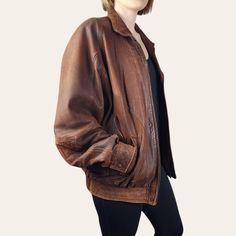 Introducing this unique 1980s vintage distressed leather Bomber Jacket in a rustic brown!  Perfect for those with a love for vintage fashion, this leather jacket exudes cool, retro vibes. The distressed look design adds a touch of edginess, while the brown leather gives it a classic look. Stand out from the crowd in this one-of-a-kind piece that combines style and nostalgia effortlessly. Add this statement jacket to your collection and rock a timeless look with a modern twist. DRY CLEANED since acquired by HRV and treated with RM Williams leather conditioner.  *Zip Closure with Snap Close Placket *Collar with Strap Detailing *2 x Welt Pockets and 2 Faux Flap Pocket (non functional) on Front *1 inner welt pocket on person's right side  *Long Sleeves with cuff -snap close *Polyester Lining B Vintage Brown Rugged Leather Jacket For Fall, Vintage Distressed Outerwear For Fall, Rugged Brown Leather Jacket, Distressed Brown Leather Jacket With Long Sleeves, Brown Distressed Leather Jacket With Long Sleeves, Vintage Distressed Leather Outerwear, Distressed Rugged Brown Outerwear, Rugged Distressed Brown Outerwear, Vintage Distressed Brown Outerwear