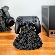 a black controller sitting on top of a wooden table