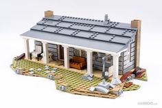 a lego model of a small house with lots of windows and doors on the front