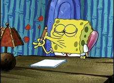 the spongebob character is sitting at a desk in front of a lamp and paper